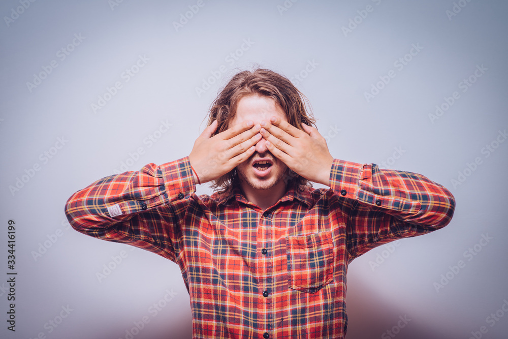 Man closes eyes with her hands Man closes eyes with her hands