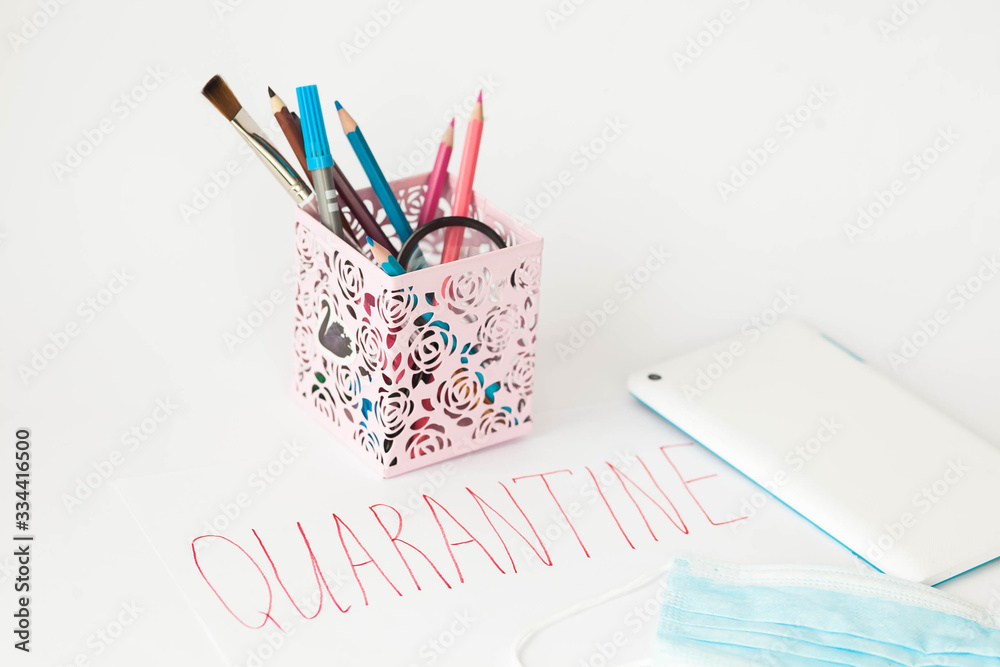 Quarantine. Business background. Medical mask, glasses, stationery, tablet, flowerpot on a bright grey background. Quarantine. Business background. Medical mask, glasses, stationery, tablet, flowerpot on a bright grey background.