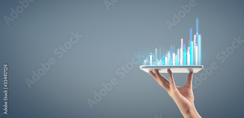  Graph growth and increase of chart positive indicators in his business,tablet in hand photo