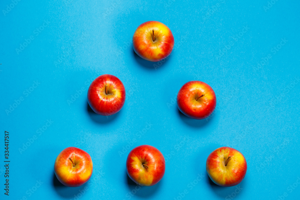 red-yellow juicy apples on a blue background. Healthy Nutrition and Vitamins
