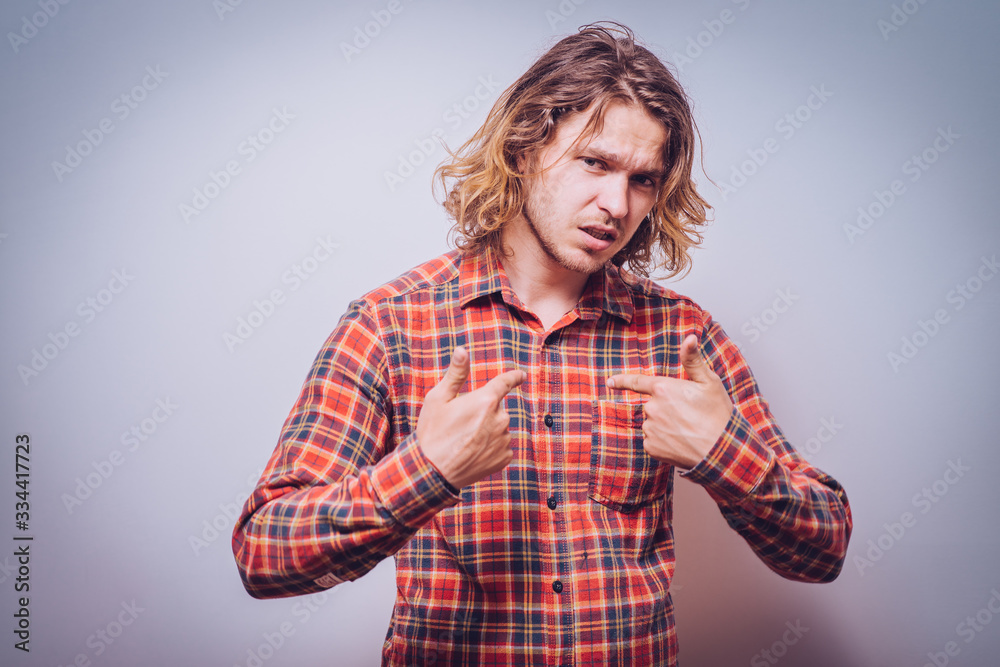 Male hand forefinger pointing to himself on the chest. Gesture. who am i. On a gray background Male hand forefinger pointing to himself on the chest. Gesture. who am i. On a gray background
