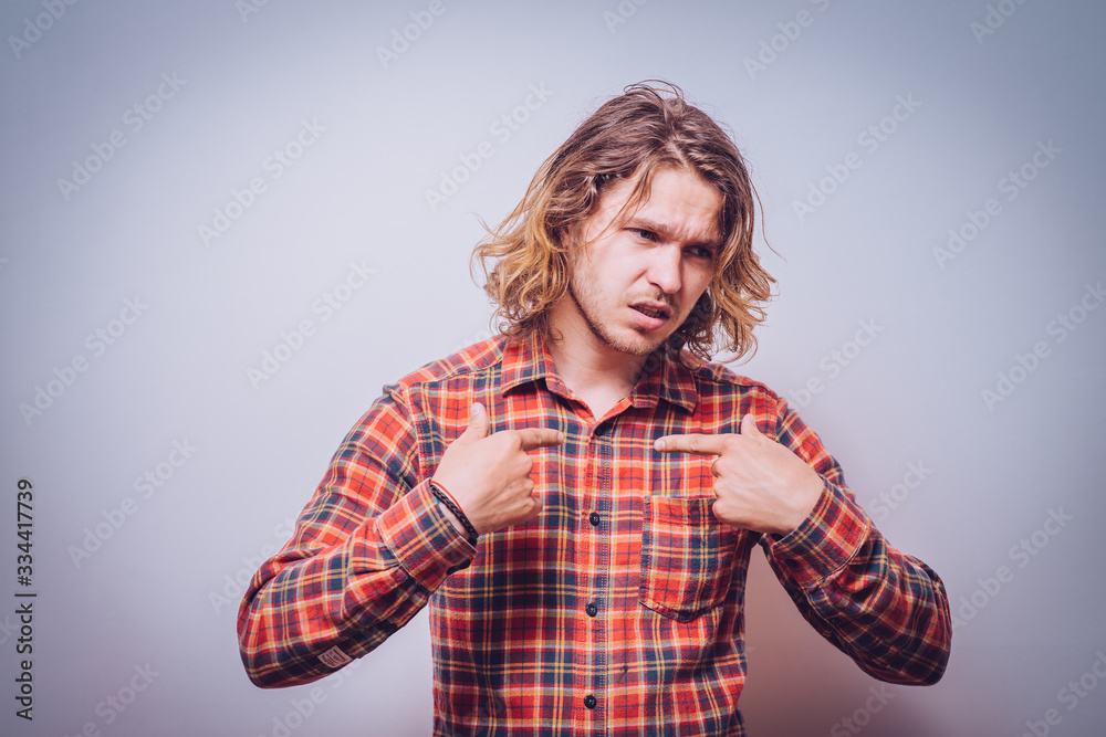 Male hand forefinger pointing to himself on the chest. Gesture. who am i. On a gray background Male hand forefinger pointing to himself on the chest. Gesture. who am i. On a gray background