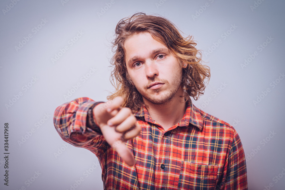 man showing a thumb down gesture man showing a thumb down gesture