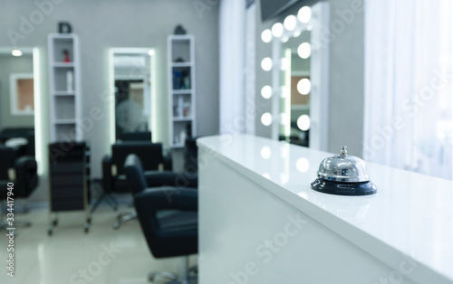 Focus on button to call in beauty salon © Prostock-studio