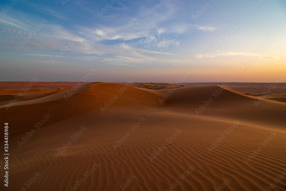 Sunset on sand dune in Wahiba sands desert near Bidiyya in Oman