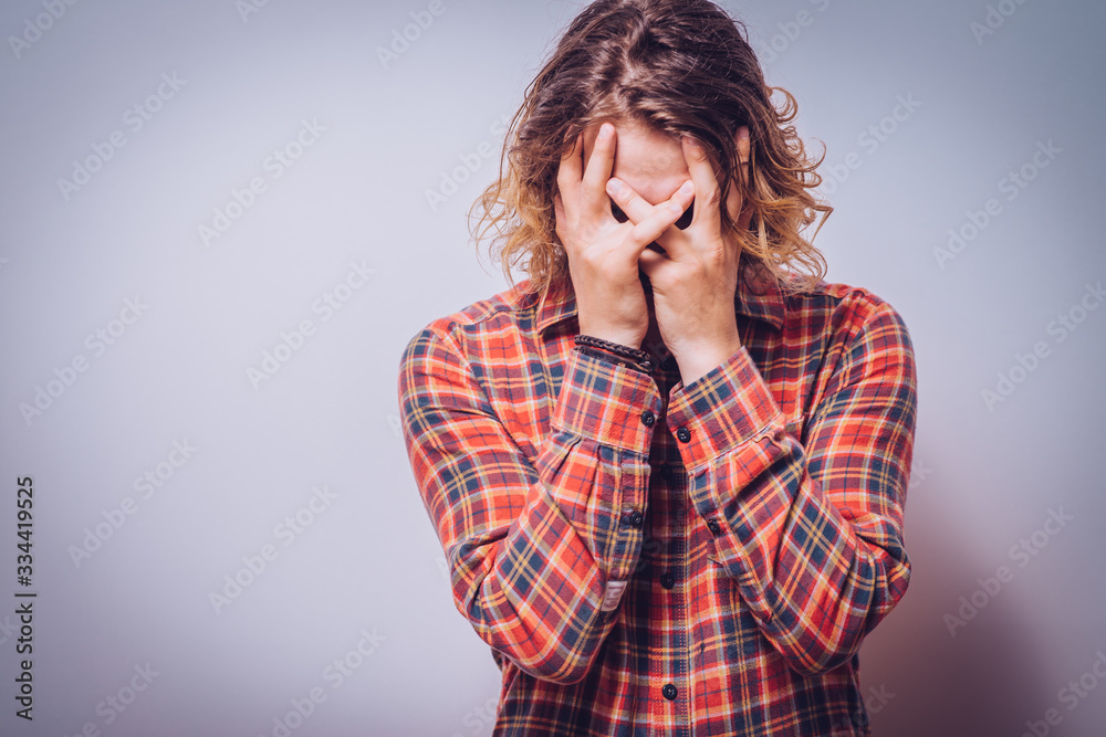 Man covering his face Man covering his face