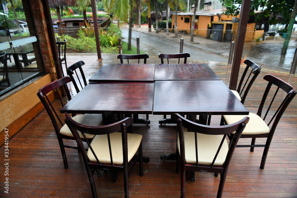 table with chairs on the veranda against the rain