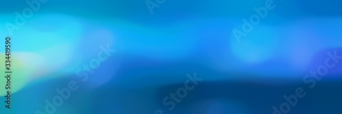 blurred bokeh horizontal header background with dodger blue, sky blue and teal green colors and free text space
