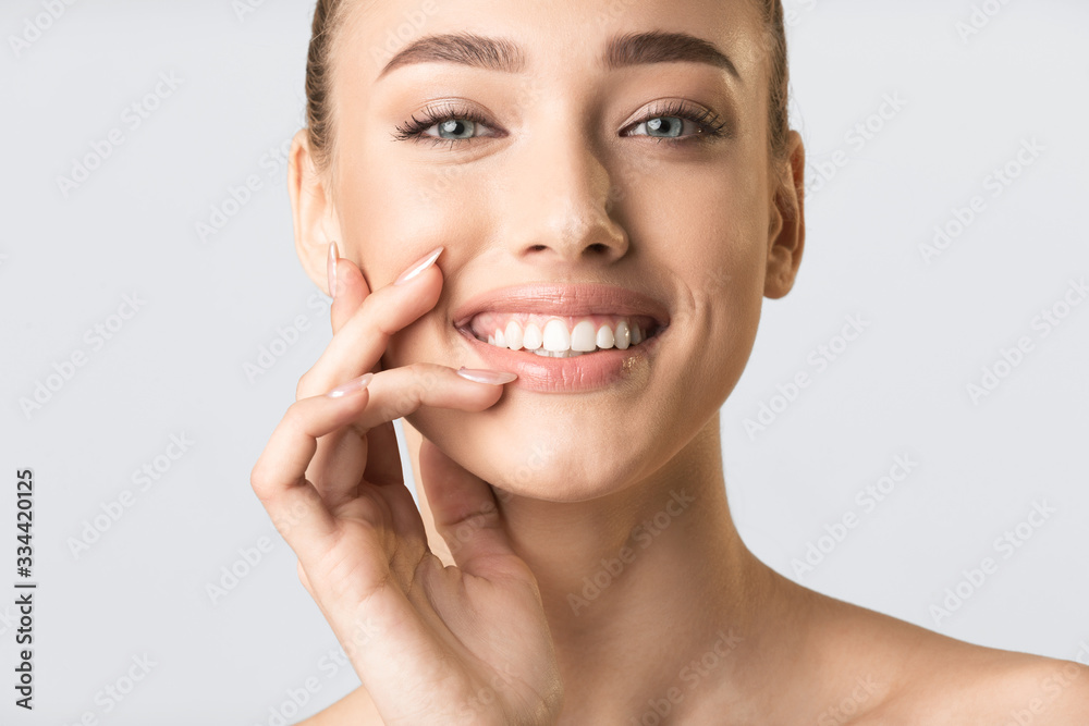 Pretty Blonde Girl Touching Lips Smiling To Camera In Studio Pretty Blonde Girl Touching Lips Smiling To Camera In Studio