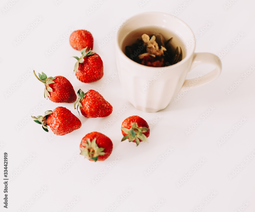 Green tea with strawberries on a white background. Flat lay, top view Green tea with strawberries on a white background. Flat lay, top view