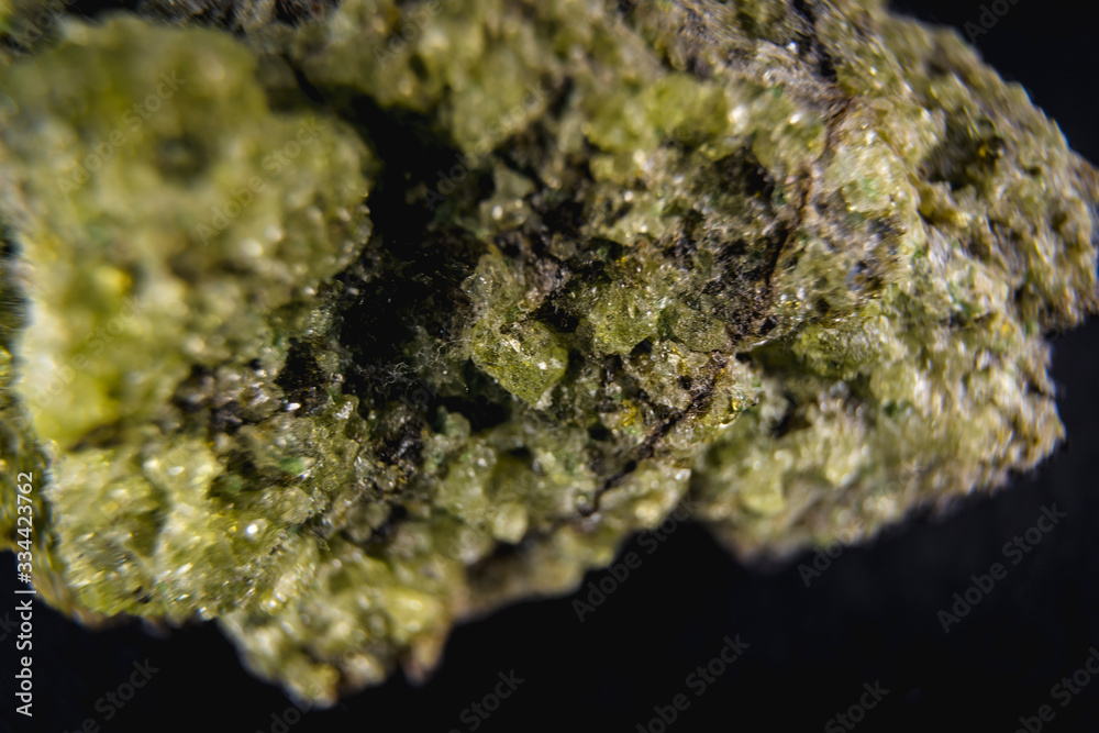 Detail of a stone with a very beautiful green mineral with a black background. Macro photography Detail of a stone with a very beautiful green mineral with a black background. Macro photography