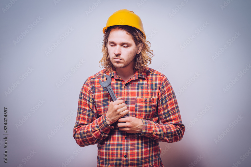Portrait of young handyman holding a wrench