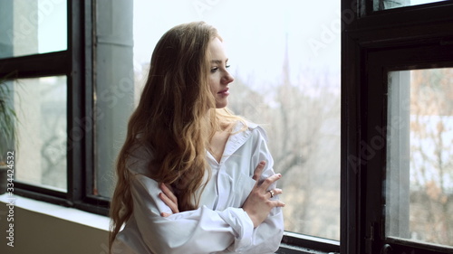 Portrait Of Young Red-Haired Girl By The Window.