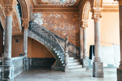Photography Old concrete shabby rounded staircase with a statue in an old Spanish-style colo
