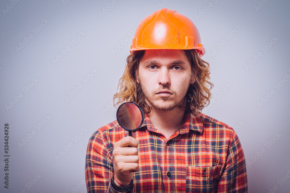 builder with magnifying glass builder with magnifying glass