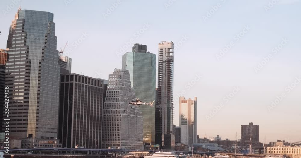 A helicopter flying in front of the skyscrapers of Manhattan in New York City. A helicopter flying in front of the skyscrapers of Manhattan in New York City.