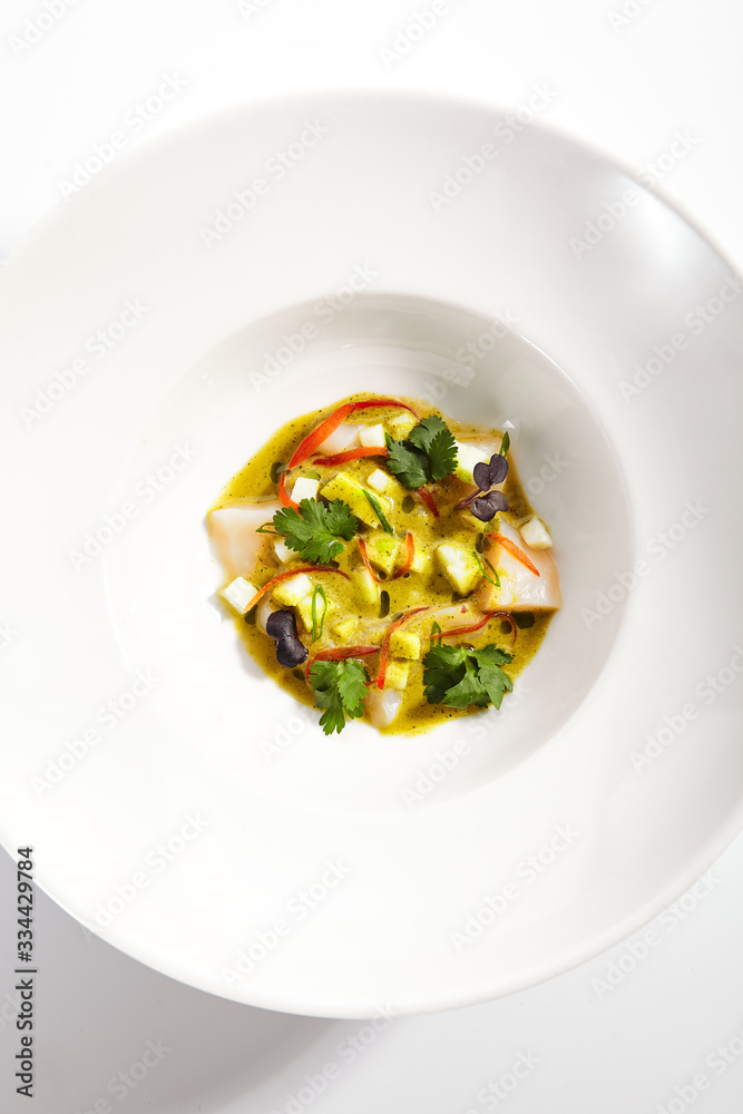 Scallop in light apple dressing in plate Scallop in light apple dressing in plate