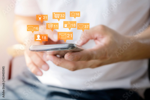 Close up of a man using mobile smart phone. Communication icons