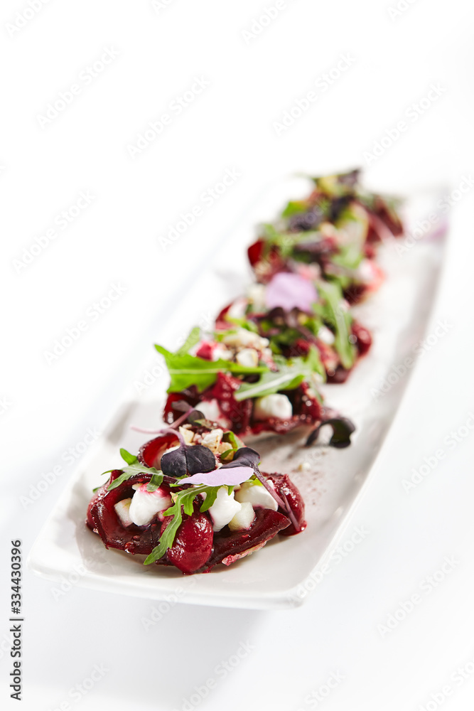 Beetroot tartare with goat cheese on tray Beetroot tartare with goat cheese on tray