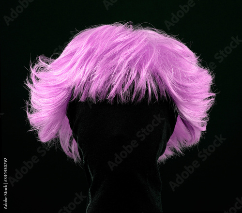 Obraz w ramie Pink hair wig isolated on black background