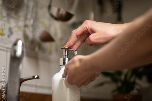 Closeup shot of a woman applying soap on her hands
