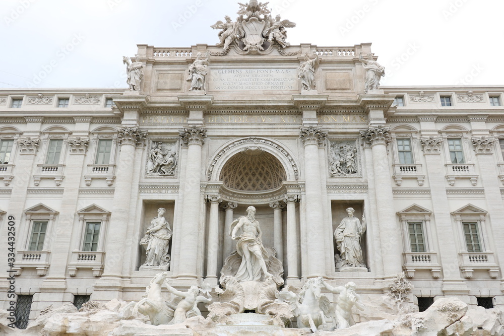Trevi Fountain with baroque sculptures in travertine marble.