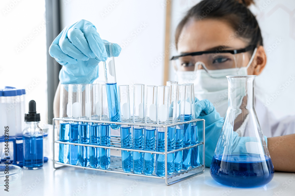 Scientist or medical in lab working in biotechnological laboratory using equipment for research with mixing reagents in glass flask in clinical laboratory Scientist or medical in lab working in biotechnological laboratory using equipment for research with mixing reagents in glass flask in clinical laboratory