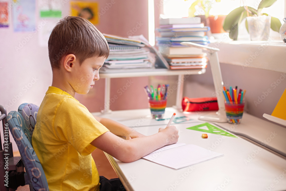 Child doing homework with books and textbooks at home. Learning at home, self quarantine concept. Family at home. Epidemic of coronavirus. Self-isolation, home quarantine. Distance learning at home. Child doing homework with books and textbooks at home. Learning at home, self quarantine concept. Family at home. Epidemic of coronavirus. Self-isolation, home quarantine. Distance learning at home.