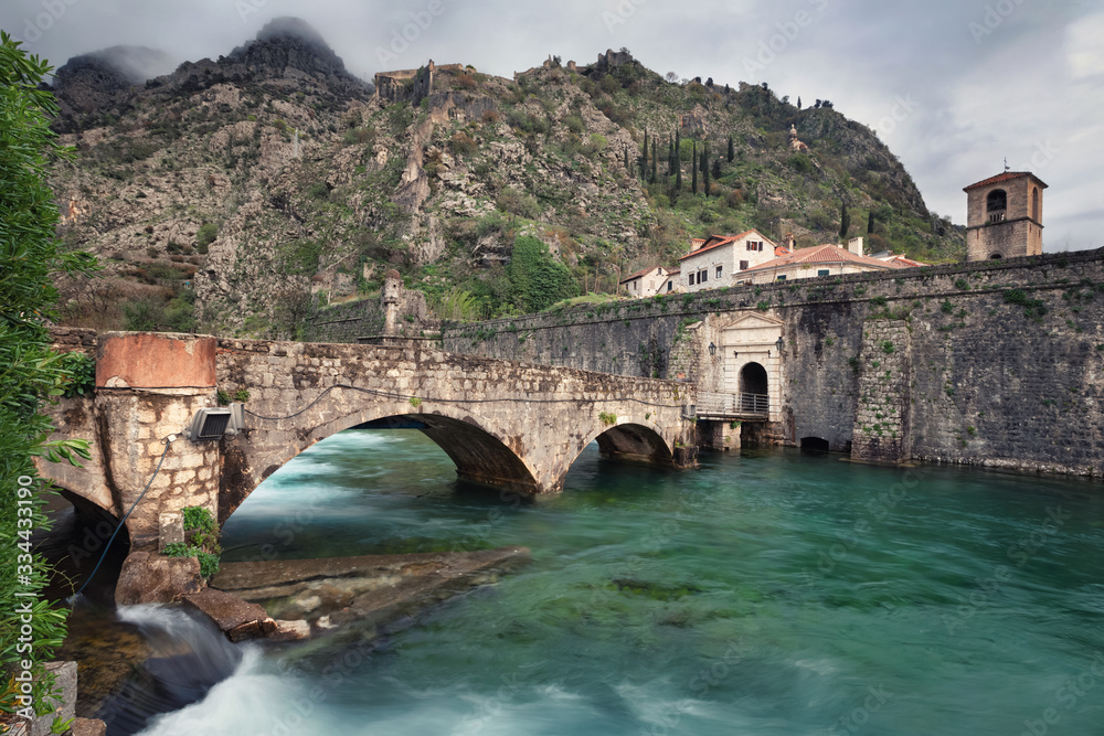 Kotor, Montenegro. Old stone bridge across Scurda river and gate to old town
