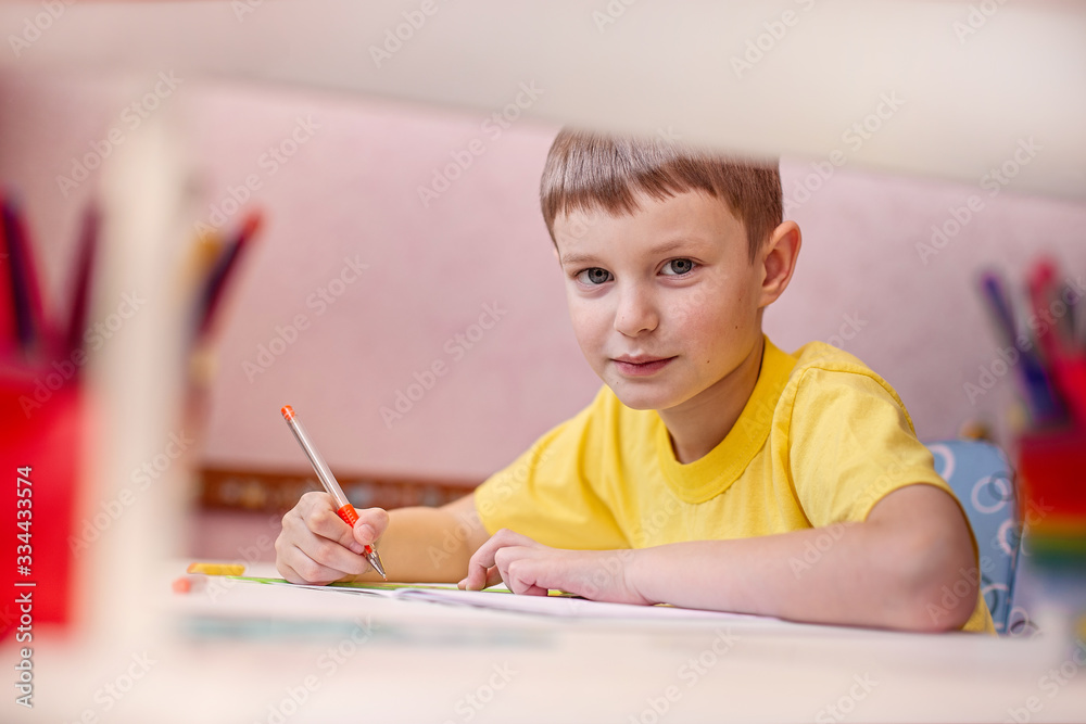 Child doing homework with books and textbooks at home. Learning at home, self quarantine concept. Family at home. Epidemic of coronavirus. Self-isolation, home quarantine. Distance learning at home. Child doing homework with books and textbooks at home. Learning at home, self quarantine concept. Family at home. Epidemic of coronavirus. Self-isolation, home quarantine. Distance learning at home.