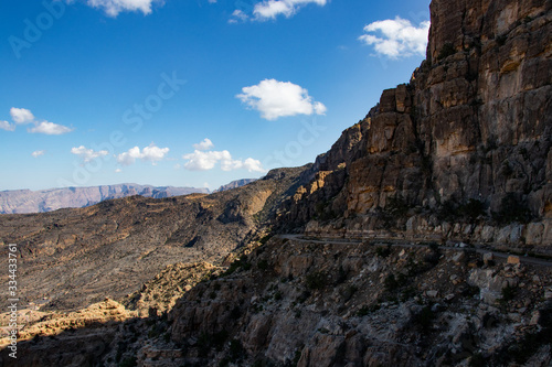 Mountain and valley view along Wadi Sahtan road in Al Hajir mountains between Nizwa and Mascat in Oman photo