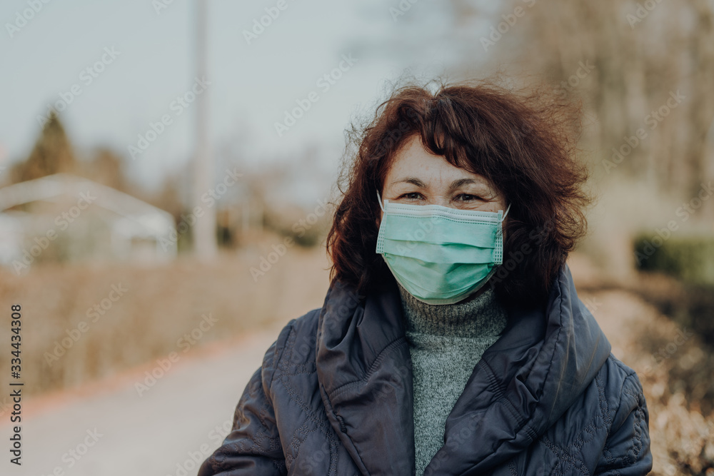 elderly woman wearing facial mask and gloves to prevention of infection elderly woman wearing facial mask and gloves to prevention of infection