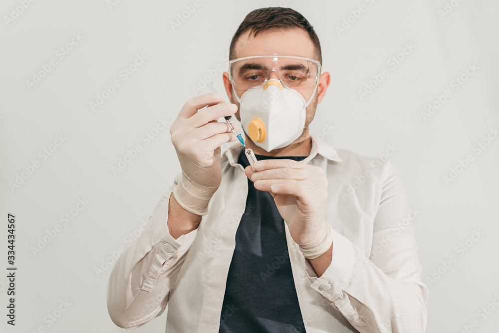 brunette man medical doctor scientist in glasses and protective mask with syringe vaccine in hands in hospital, laboratory. Medication for coronavirus illness, infection, quarantine, surgical bandage brunette man medical doctor scientist in glasses and protective mask with syringe vaccine in hands in hospital, laboratory. Medication for coronavirus illness, infection, quarantine, surgical bandage