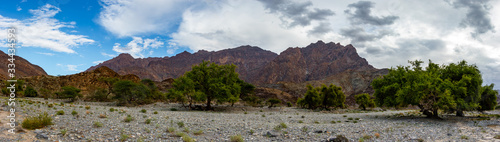 Mountain and valley view along Wadi Sahtan road and snake canyon in Al Hajir mountains between Nizwa and Mascat in Oman