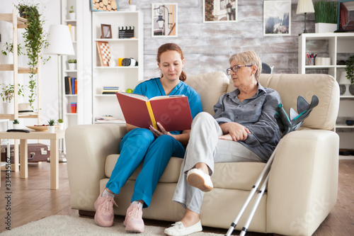 Young nurse sitting on couch in nursing home