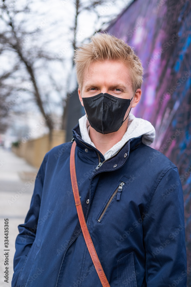European man travel wearing black face protection agains coronavirus European man travel wearing black face protection agains coronavirus