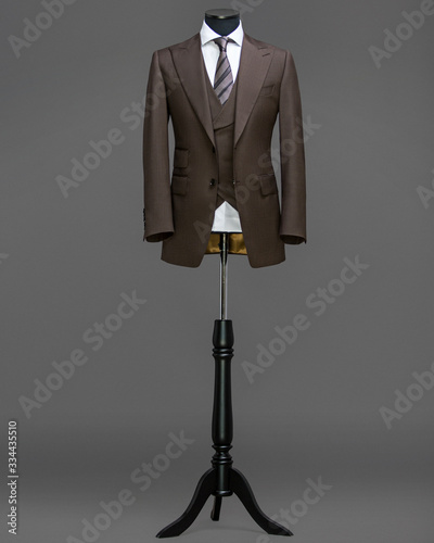 Atelier to repair clothes, Stylish look, Fashion look, Men look, Wedding style, Fashion concept, Brand clothing, Classic costume,Suit on grey background. Store display. Classic style.