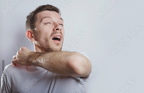 Man sneezes elbow photo
