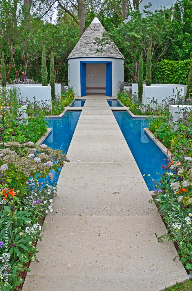 A modern showgarden with water feature, alcoves for flowers.