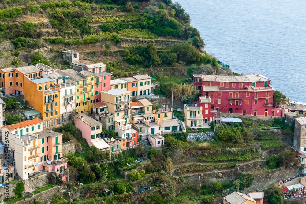 Nice aerial landscape view of the little town of Manarola in the Cinque Terre in Liguria Italy. It is a small colorful village perched on the rocks with a fantastic view of the Mediterranean sea