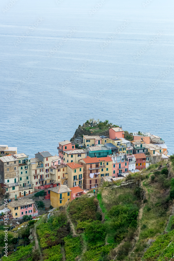 Aerial detail landscape view of the little town of Manarola in the Cinque Terre in Liguria Italy. It is a small colorful village perched on the rocks with a fantastic view of the Mediterranean sea