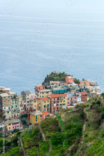 Aerial detail landscape view of the little town of Manarola in the Cinque Terre in Liguria Italy. It is a small colorful village perched on the rocks with a fantastic view of the Mediterranean sea © eugpng