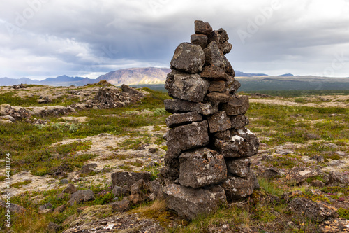 stacked pile of stones in iceland against the background of the valley © Sergei