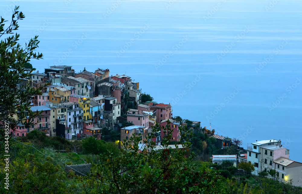Nice aerial landscape view of the little town of Corniglia in the Cinque Terre in Liguria Italy at dusk. A small colorful village perched on the rocks with a fantastic view of the Mediterranean sea