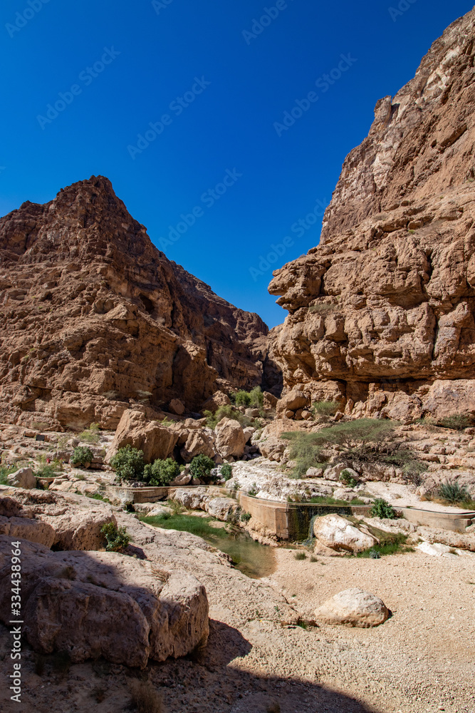 Hike through narrow valley of Wadi Shab in Tiwi near Mascat in Oman