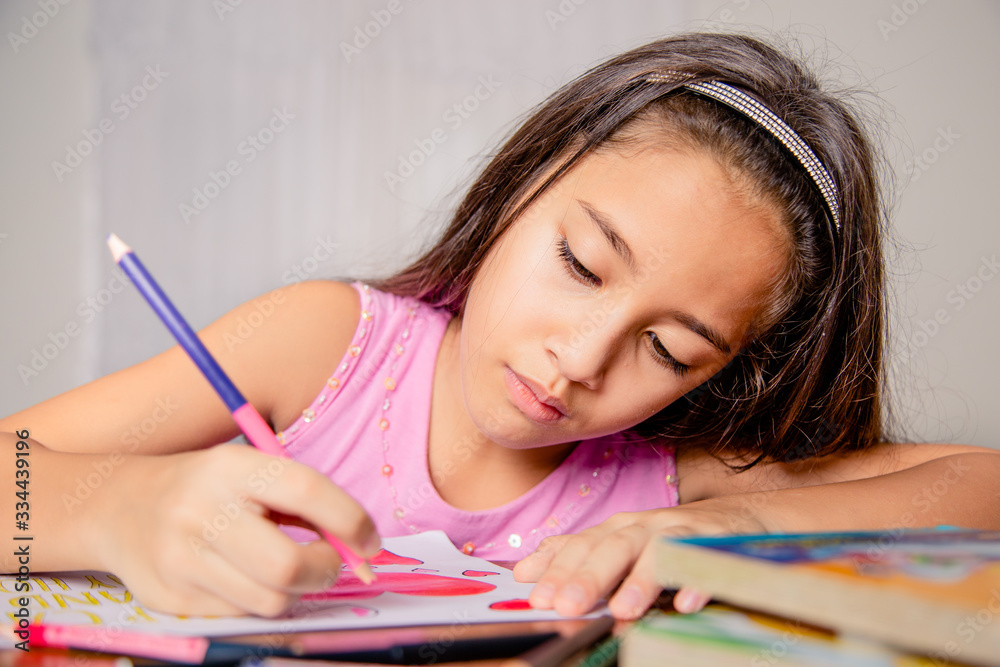 girl drawing slogan stay home, half body, in interior of latin home girl drawing slogan stay home, half body, in interior of latin home