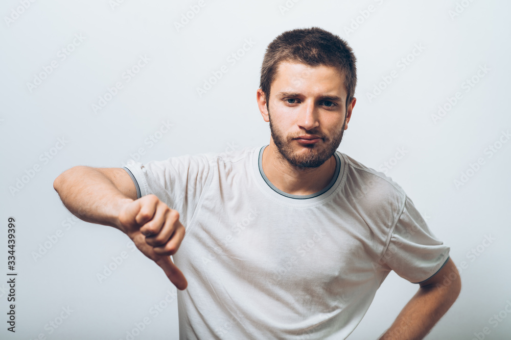 man showing a thumb down gesture man showing a thumb down gesture