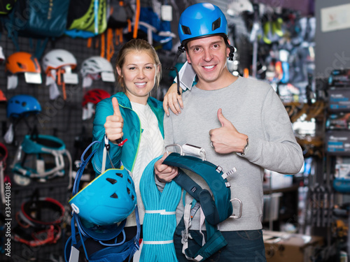 Young couple in sports shop choosing sports equipment