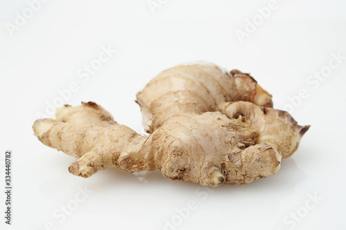 Close up of Fresh Ginger root or rhizome isolated on white