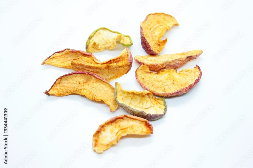 pieces of dry apples placed on a white background pieces of dry apples placed on a white background